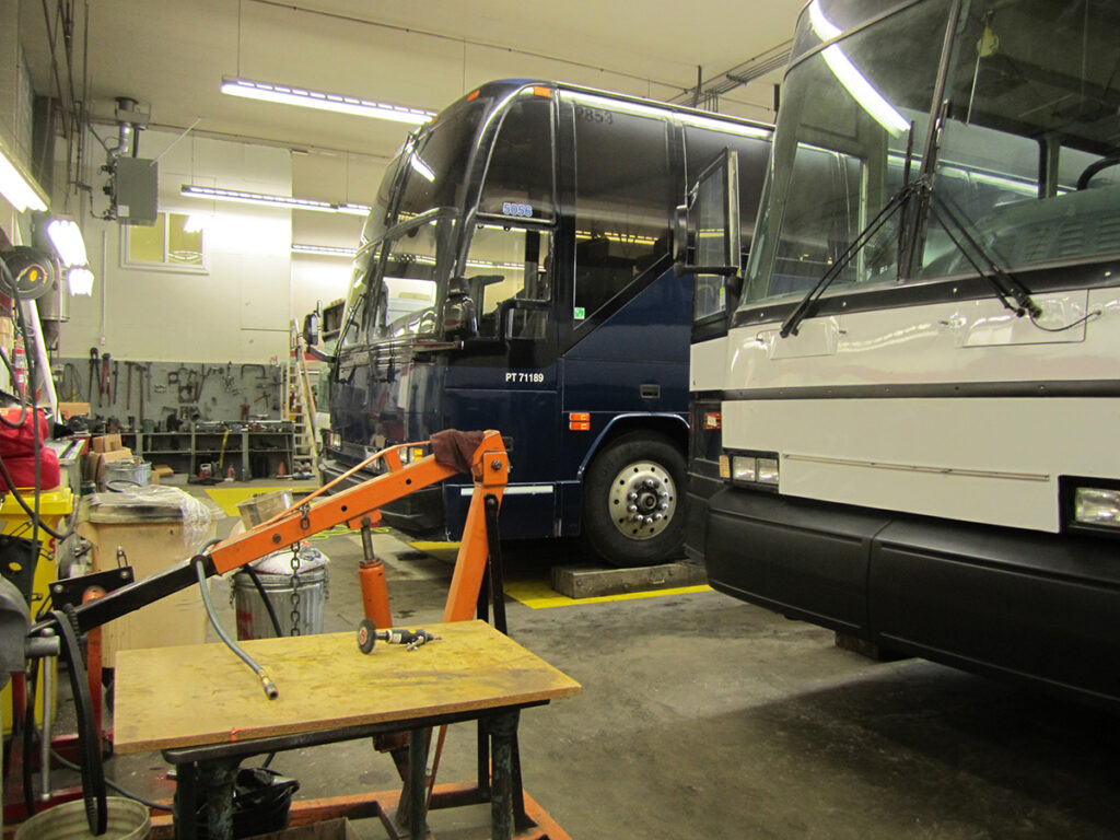 Tour buses in a repair shop